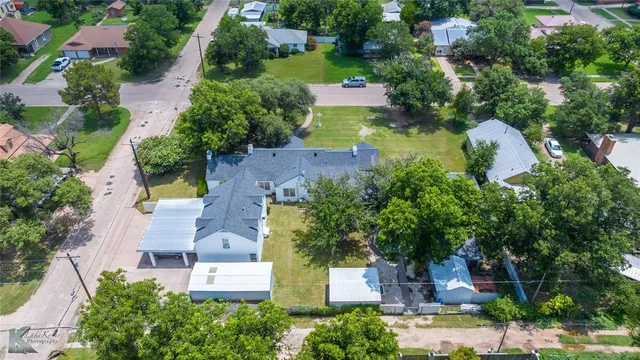 an aerial view of residential houses with outdoor space and street view