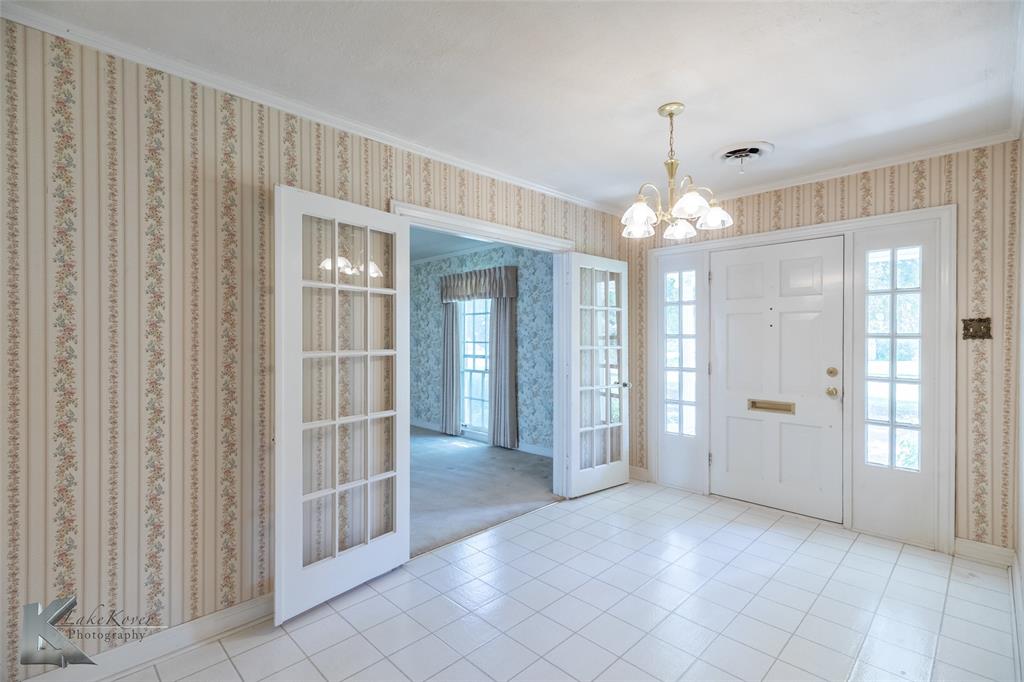 907 North Ave G Haskell, TX 79521 - Photo 4 of 40 a view of a hallway with chandelier and glass door