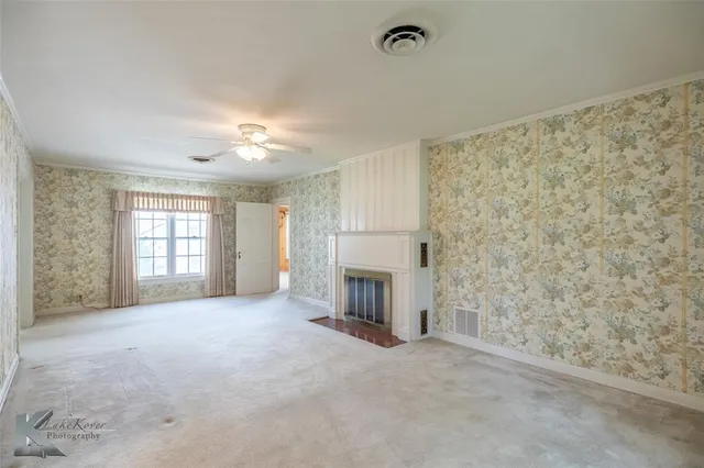 a view of empty room with a fireplace