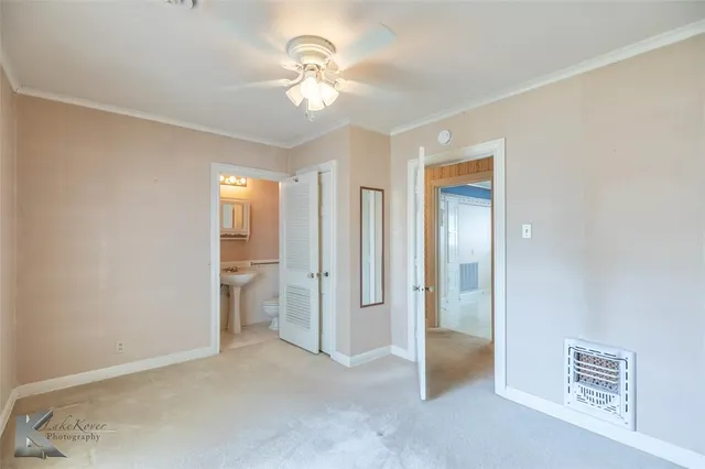 a view of an empty room with a bathroom