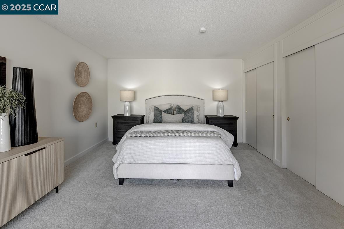 2041 Golden Rain Road, Unit 4 Walnut Creek, CA 94595 - Photo 16 of 53 a bedroom with a bed and painting on the wall