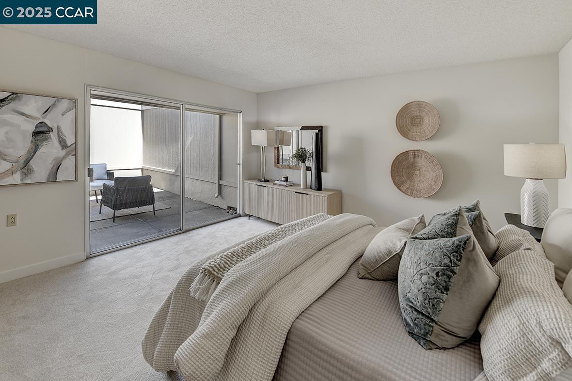 2041 Golden Rain Road, Unit 4 Walnut Creek, CA 94595 - Photo 19 of 53 a bedroom with a bed and glass window