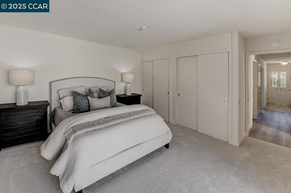 2041 Golden Rain Road, Unit 4 Walnut Creek, CA 94595 - Photo 20 of 53 a large bed sitting in a bedroom and closet