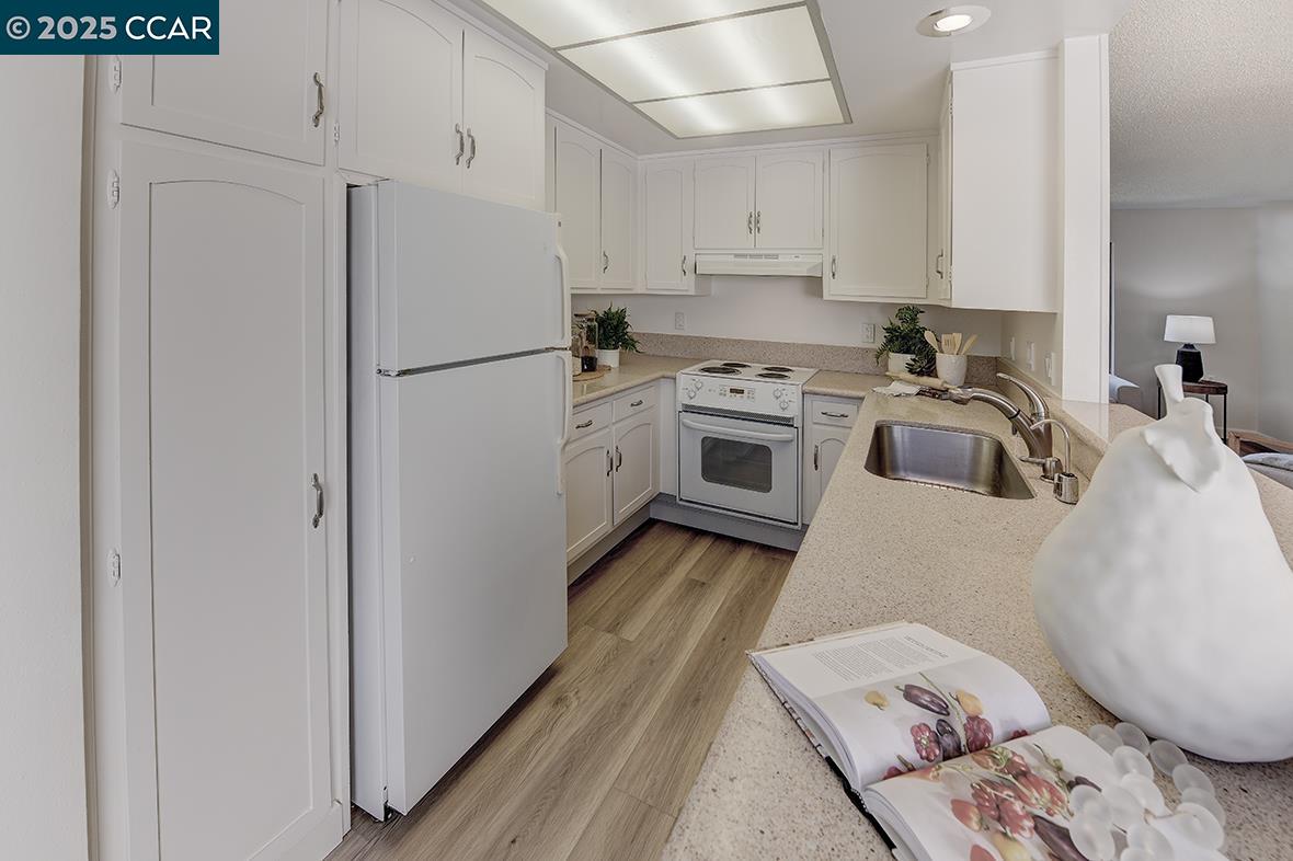 2041 Golden Rain Road, Unit 4 Walnut Creek, CA 94595 - Photo 24 of 53 a kitchen with a refrigerator sink and stove