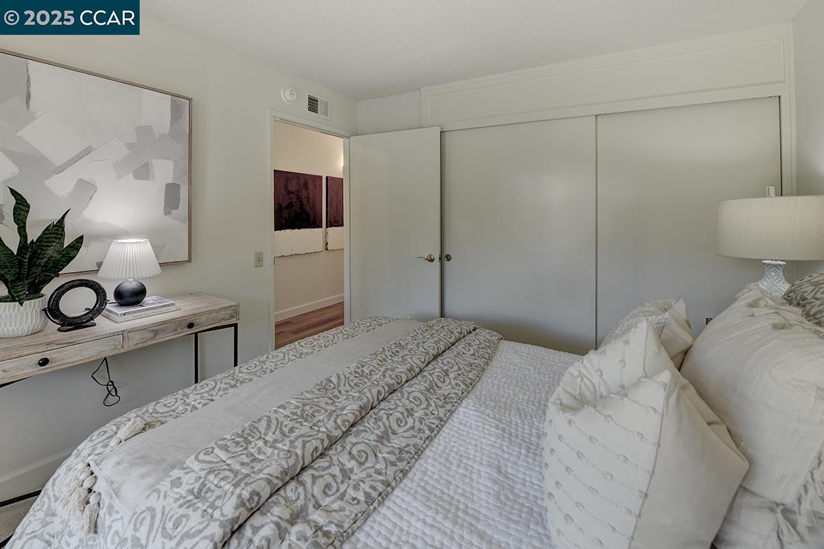 2041 Golden Rain Road, Unit 4 Walnut Creek, CA 94595 - Photo 30 of 53 a bedroom with a bed and a flat screen tv