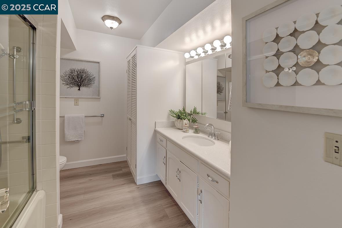 2041 Golden Rain Road, Unit 4 Walnut Creek, CA 94595 - Photo 33 of 53 a bathroom with a double vanity sink mirror and shower