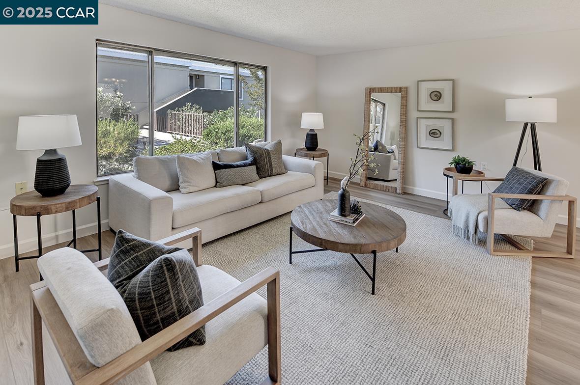 2041 Golden Rain Road, Unit 4 Walnut Creek, CA 94595 - Photo 7 of 53 a living room with furniture and a large window