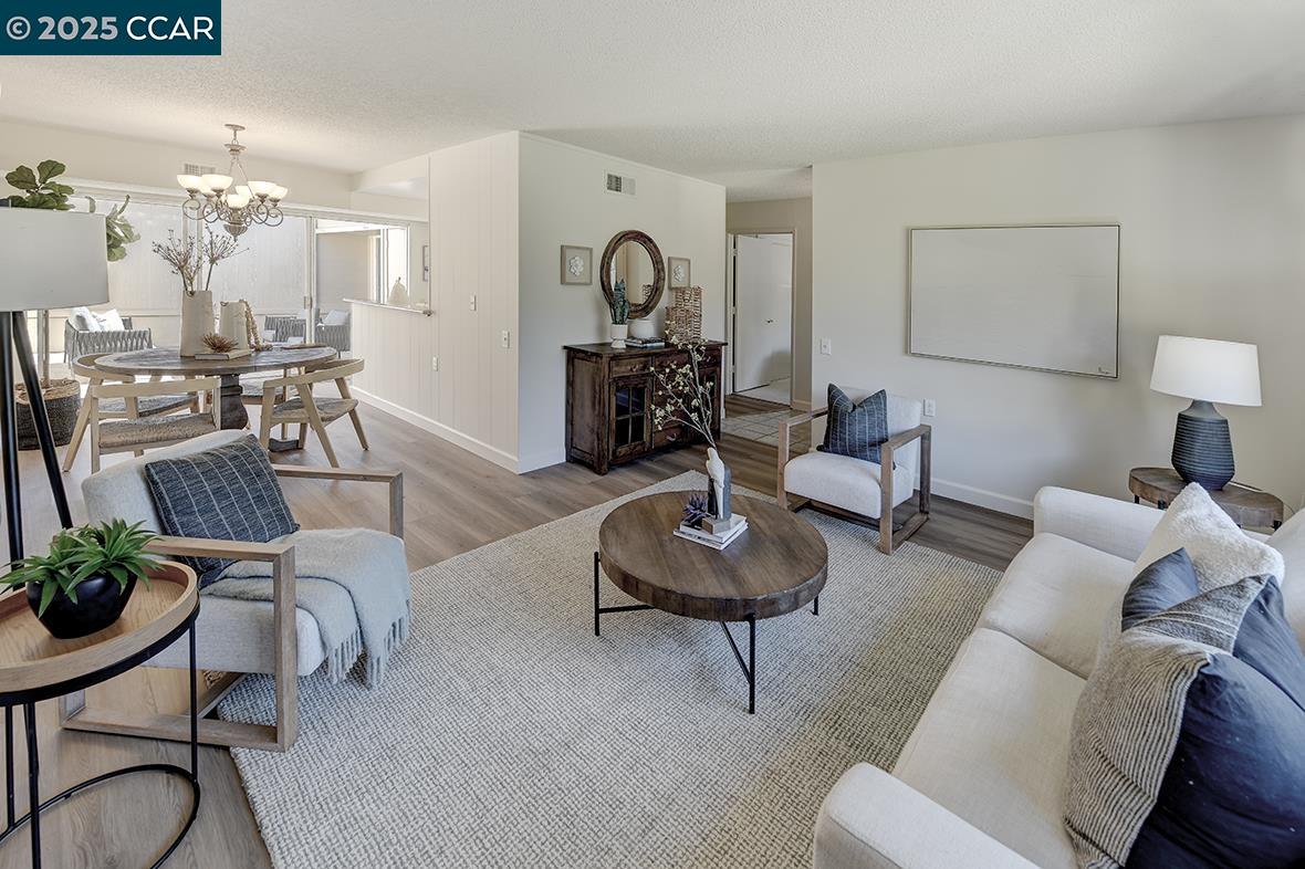 2041 Golden Rain Road, Unit 4 Walnut Creek, CA 94595 - Photo 9 of 53 a living room with furniture and a chandelier