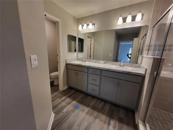 a bathroom with a double vanity sink and a mirror