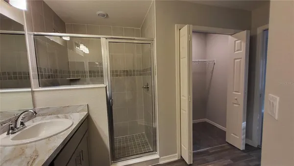 a bathroom with a shower and a sink