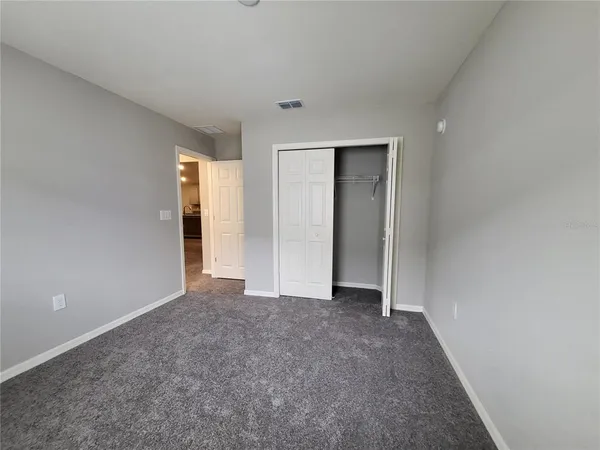 a view of empty room with closet
