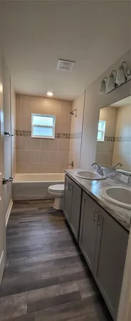 a view of hallway with wooden floor