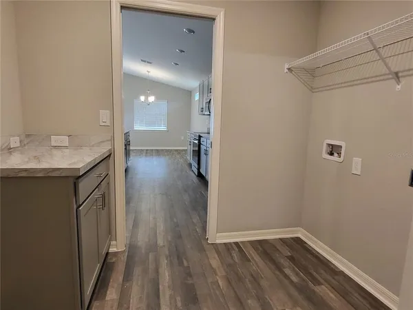 a view of a room with wooden floor