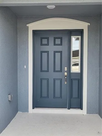 a view of a room with wooden floor and window