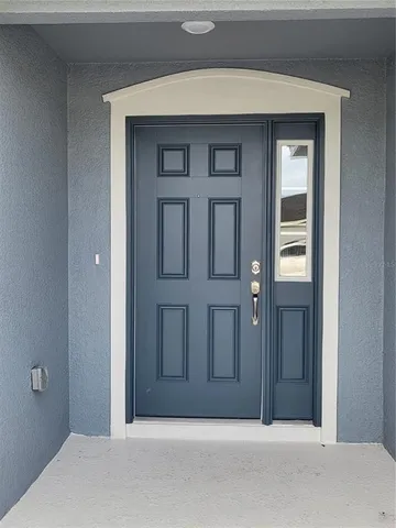 a view of a room with wooden floor and window