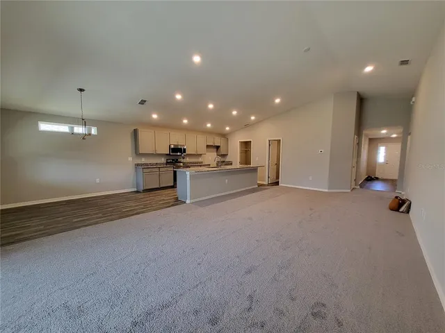 a kitchen with refrigerator and window