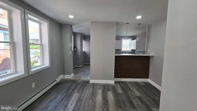 a view of a room with wooden floor