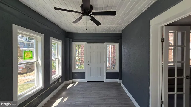a view of entryway with wooden floor and chandelier