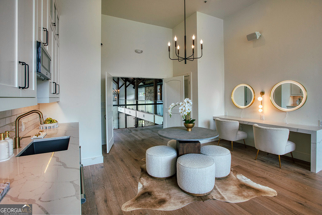 1019 Hardscrabble Road Mineral Bluff, GA 30559 - Photo 10 of 52 a dining room with furniture a chandelier and wooden floor