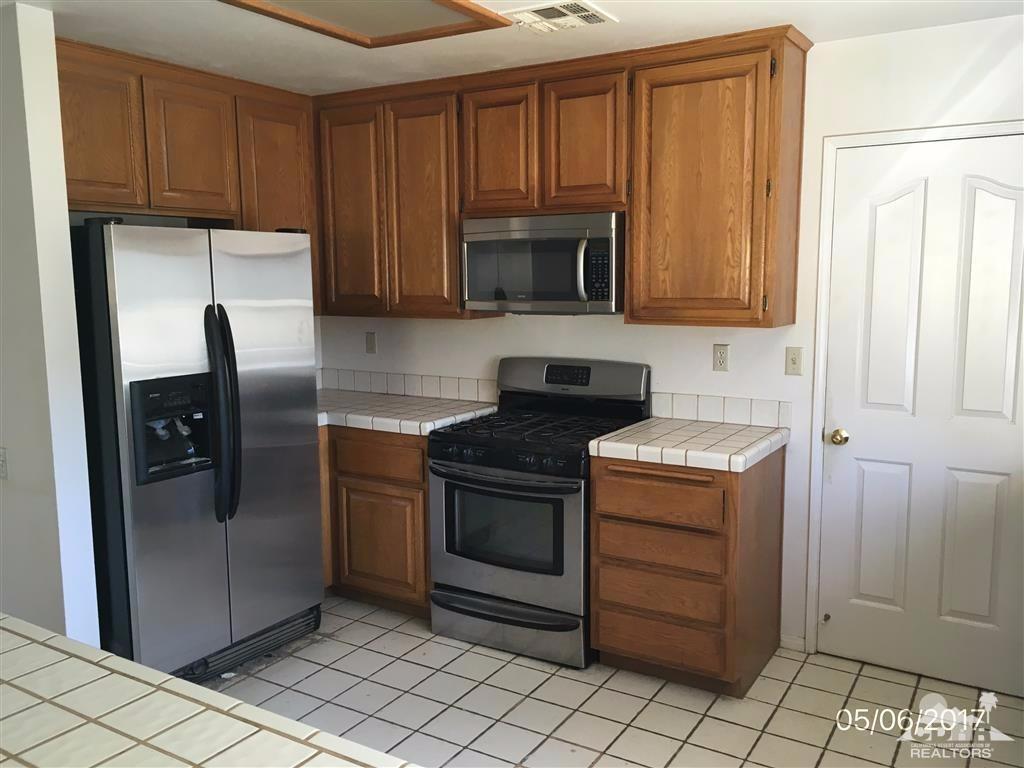 59371 Devils Ladder Road Mountain Center, CA 92561 - Photo 4 of 12 a kitchen with stainless steel appliances granite countertop a refrigerator stove and cabinets
