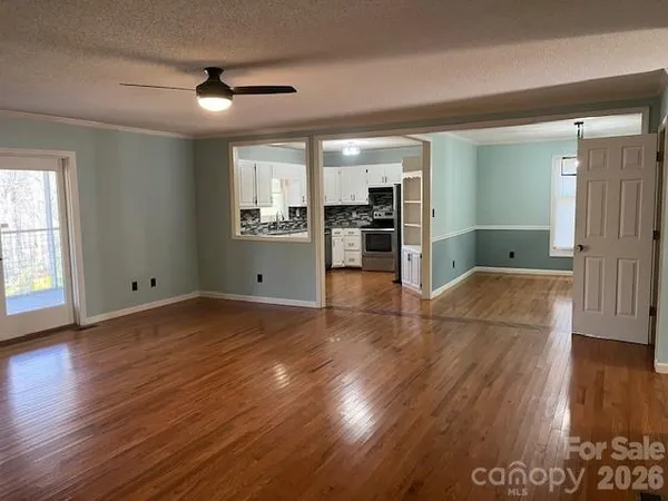 a kitchen with stainless steel appliances white cabinets a sink a stove a refrigerator and microwave