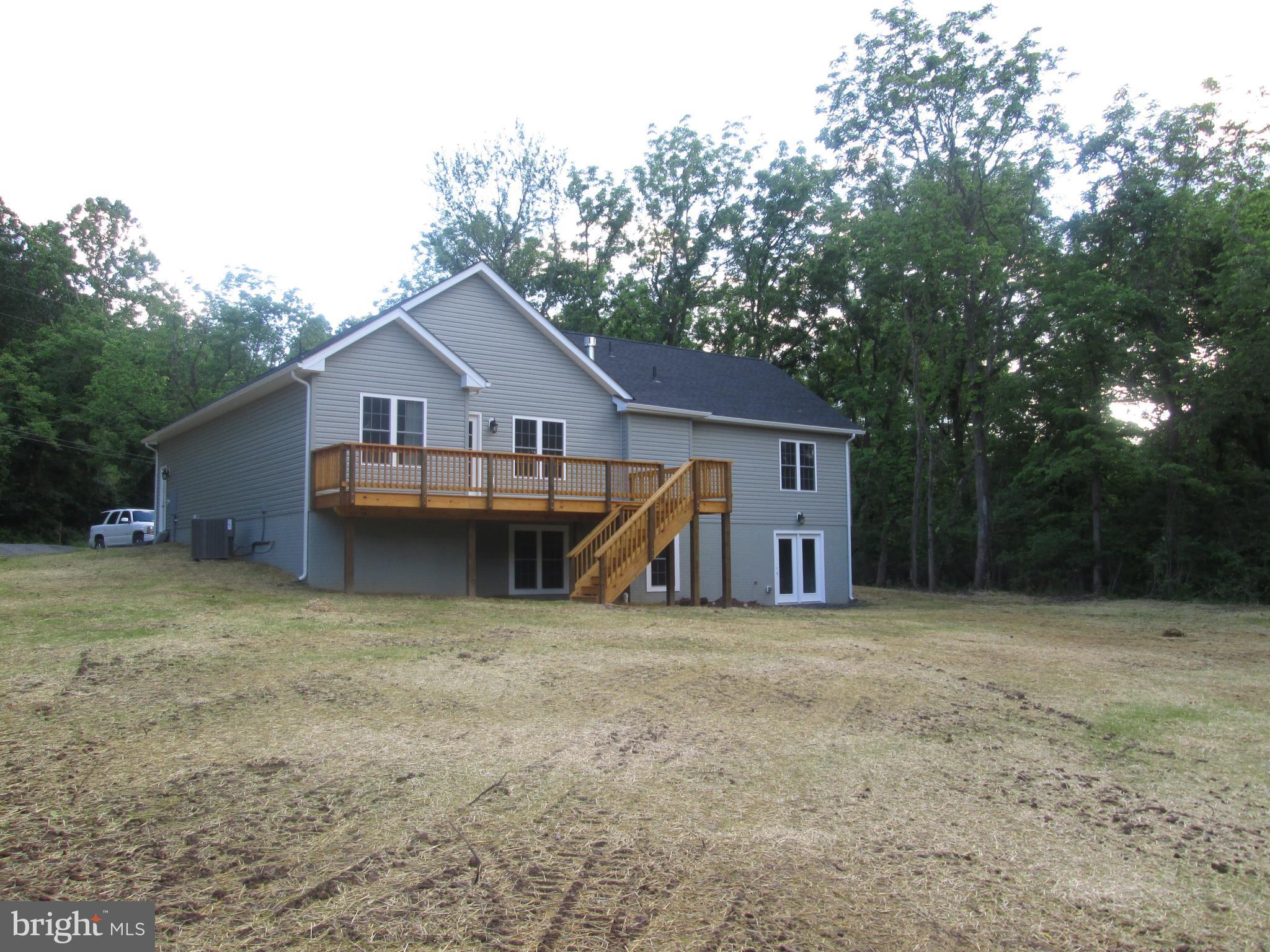 7117 Howellsville Road Boyce, VA 22620 - Photo 2 of 2 a view of a house with a backyard and a tree