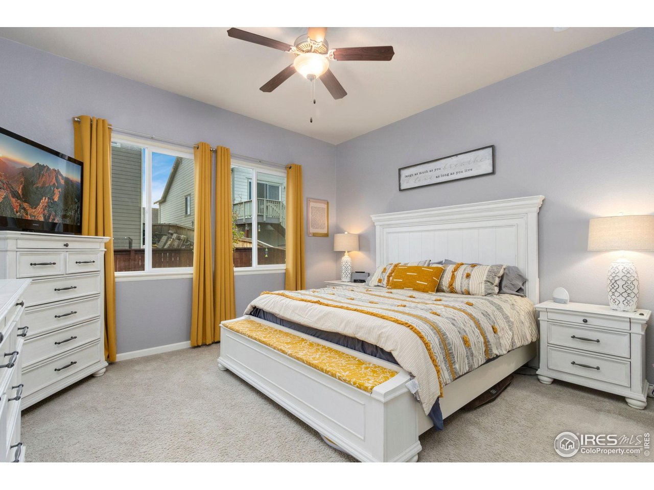 719 Wagon Bend Road Berthoud, CO 80513 - Photo 17 of 40 a bed room with a bed and a television