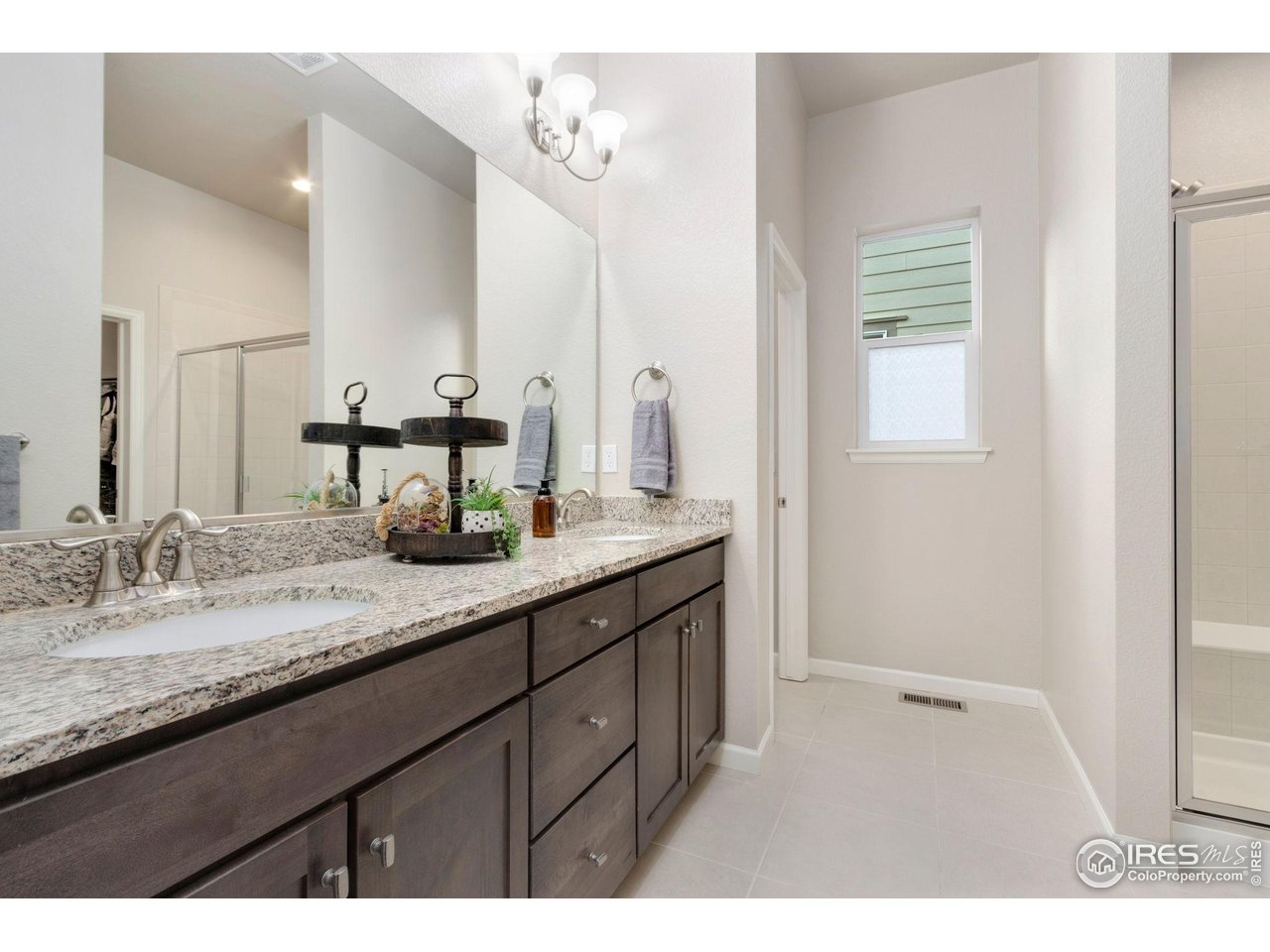 719 Wagon Bend Road Berthoud, CO 80513 - Photo 19 of 40 a bathroom with a granite countertop sink and a mirror