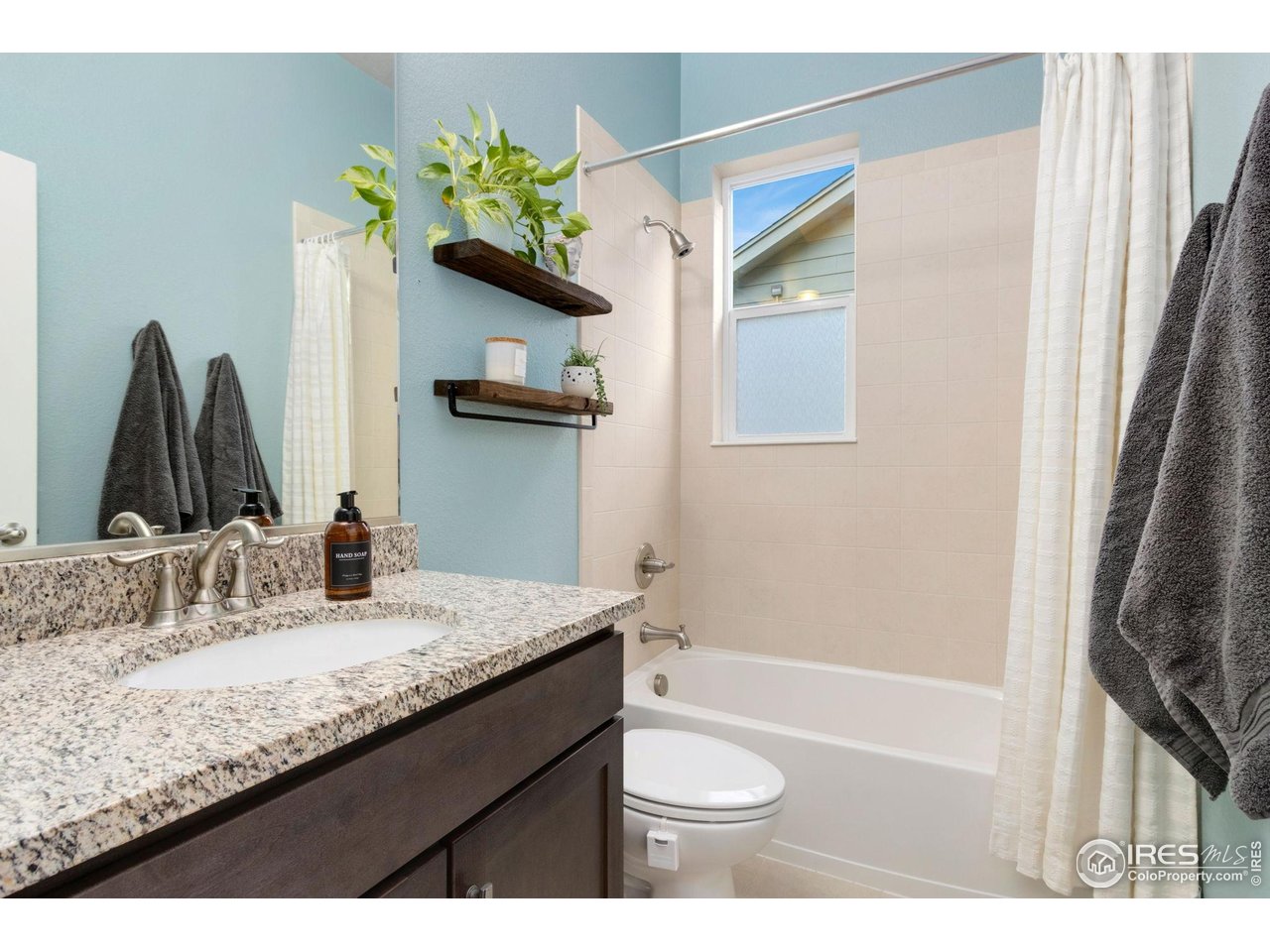 719 Wagon Bend Road Berthoud, CO 80513 - Photo 23 of 40 a bathroom with a granite countertop sink a toilet and shower