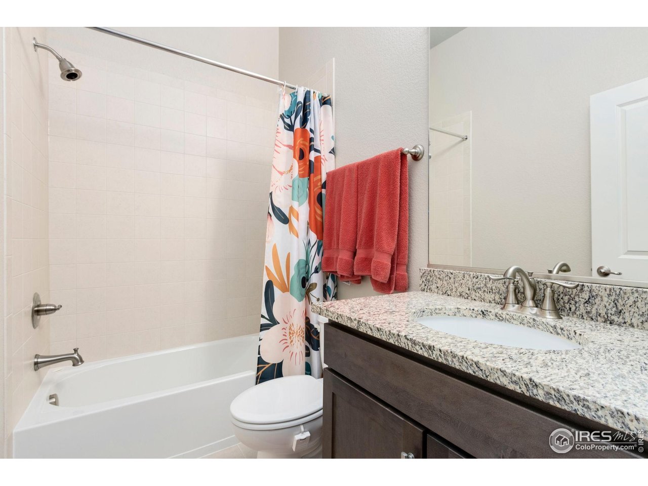 719 Wagon Bend Road Berthoud, CO 80513 - Photo 25 of 40 a bathroom with a granite countertop sink and a mirror