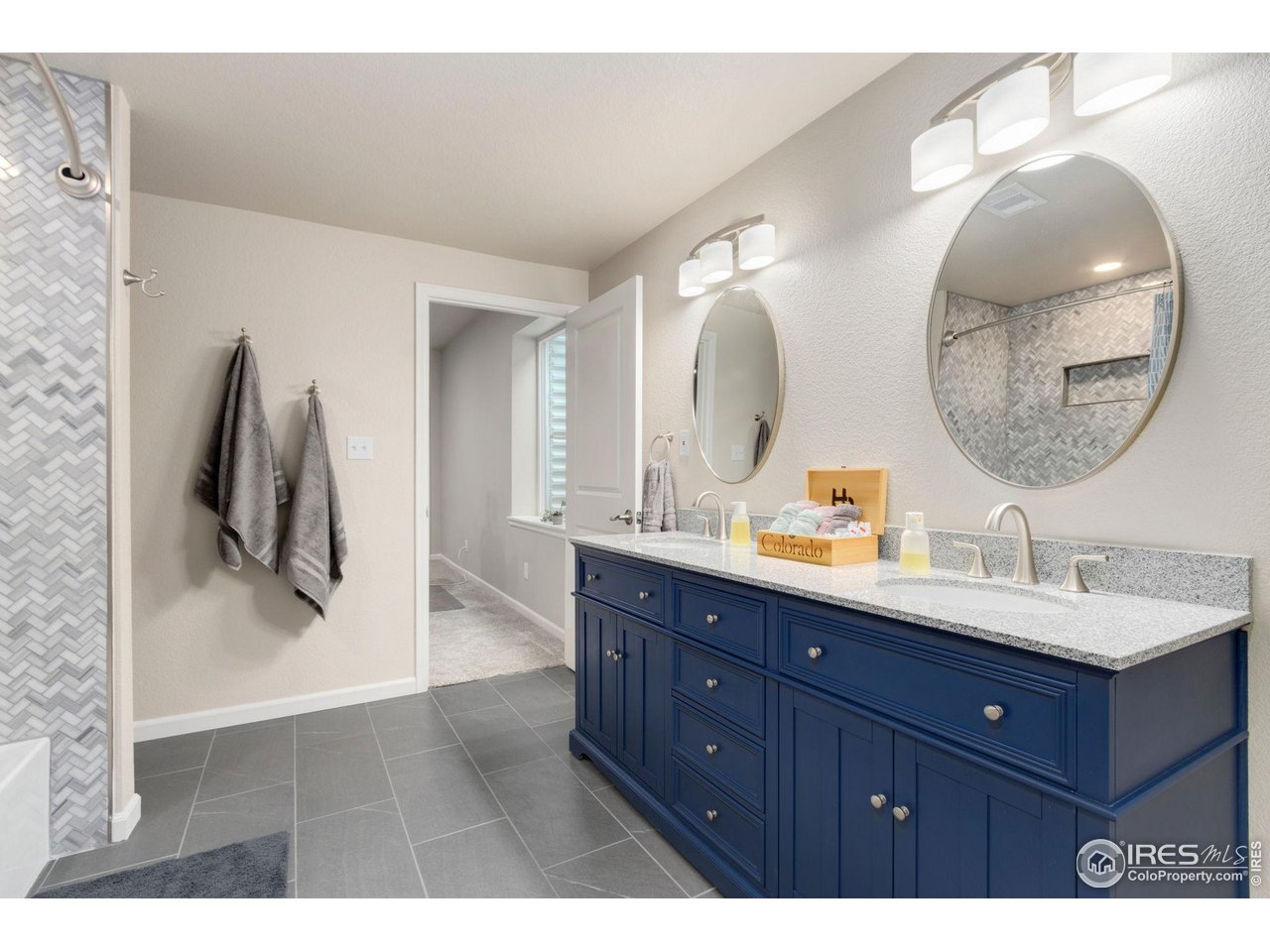 719 Wagon Bend Road Berthoud, CO 80513 - Photo 30 of 40 a bathroom with a double vanity sink and mirror