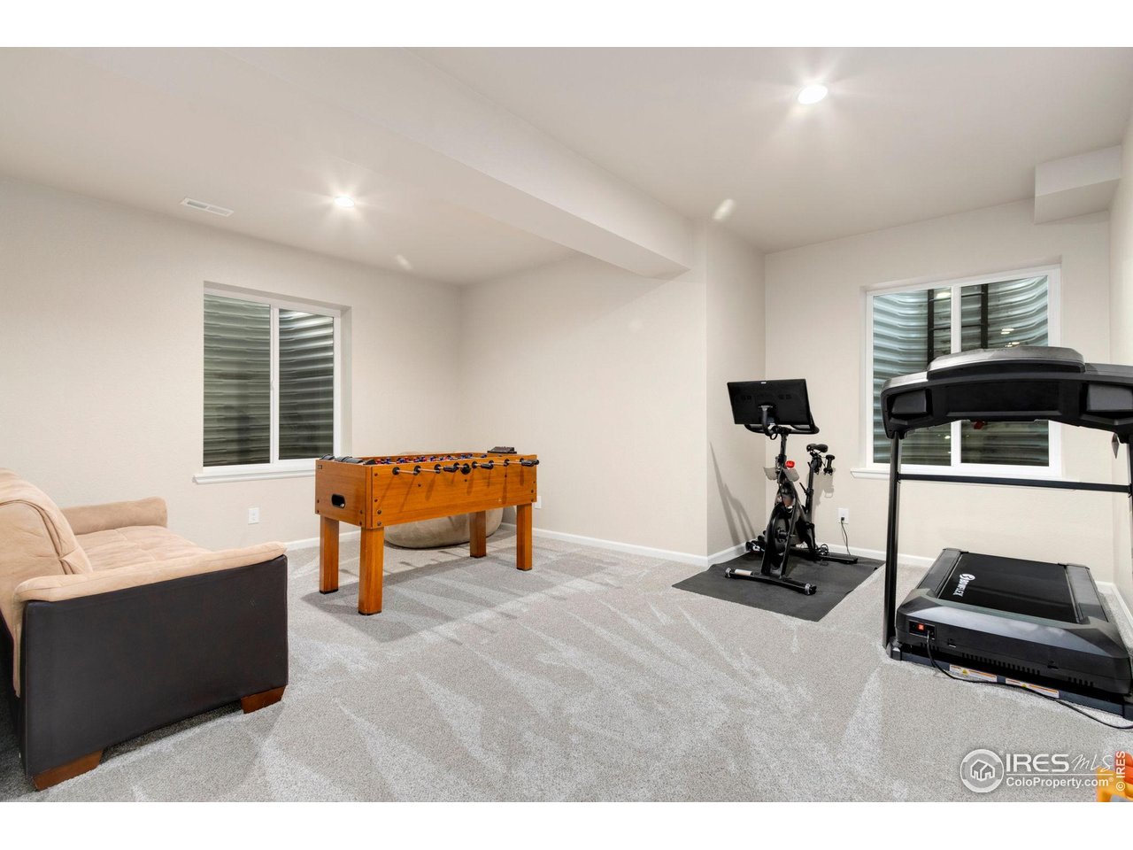 719 Wagon Bend Road Berthoud, CO 80513 - Photo 32 of 40 a living room with furniture gym equipment and a window