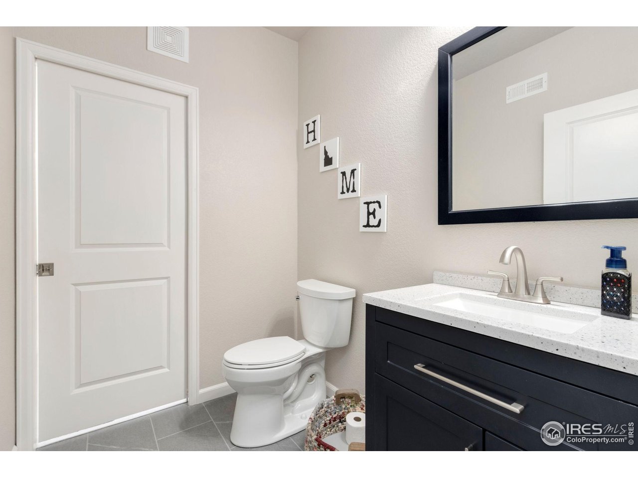 719 Wagon Bend Road Berthoud, CO 80513 - Photo 34 of 40 a bathroom with a granite countertop toilet sink and mirror