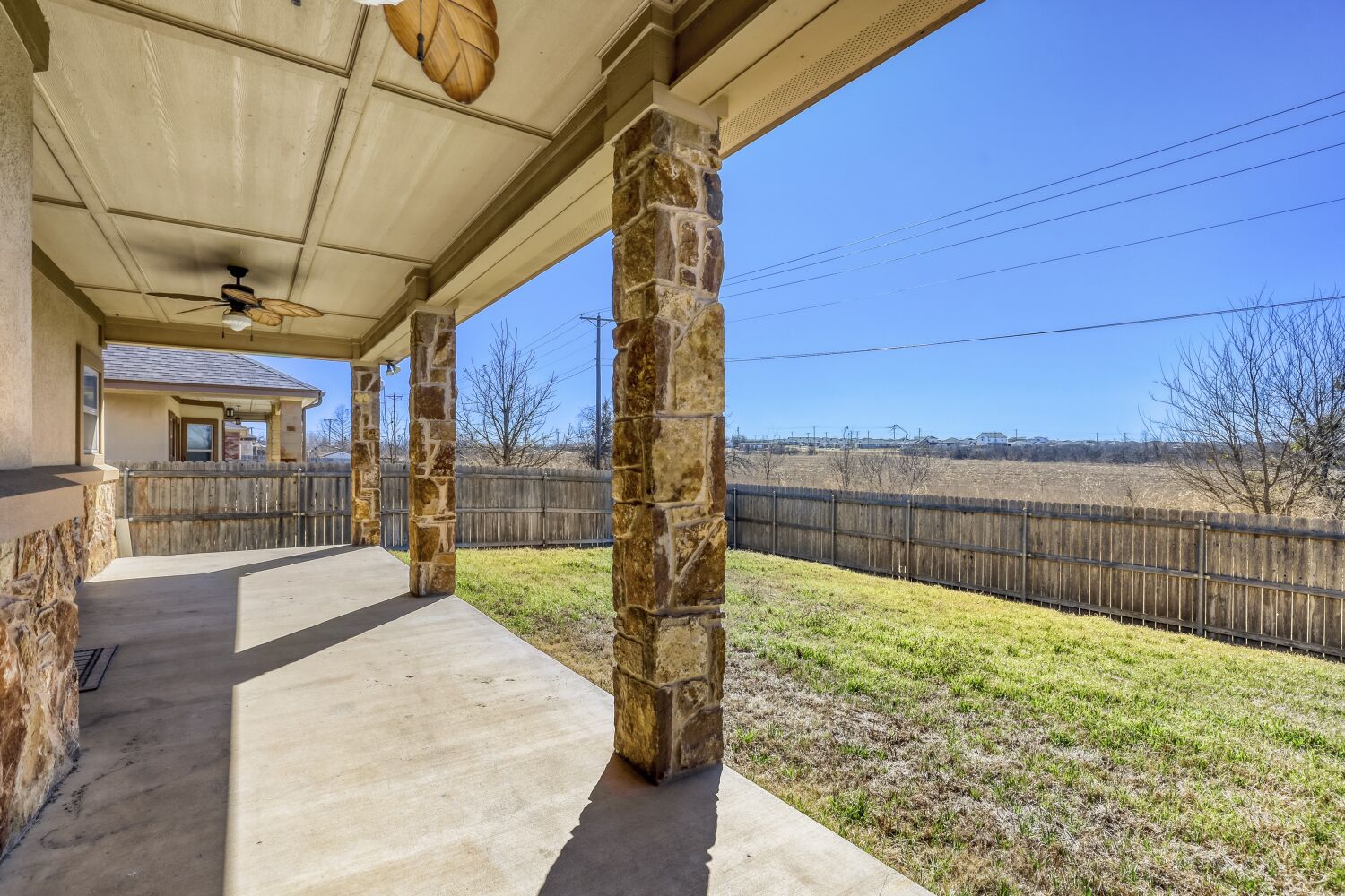 329 Jake Drive Jarrell, TX 76537 - Photo 16 of 17 Fenced backyard featuring a ceiling fan and a patio area