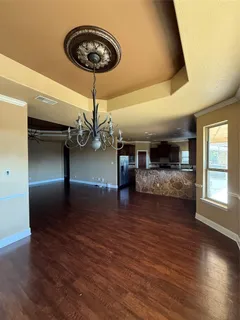 a view of livingroom and kitchen with wooden floor