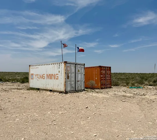 a sign that is sitting in the middle of a field