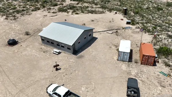 an aerial view of a house with a yard