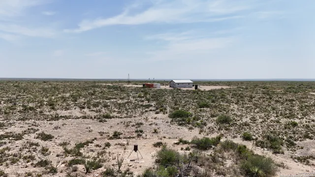 an aerial view of a house with a beach