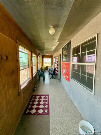 a hallway with furniture and a gate