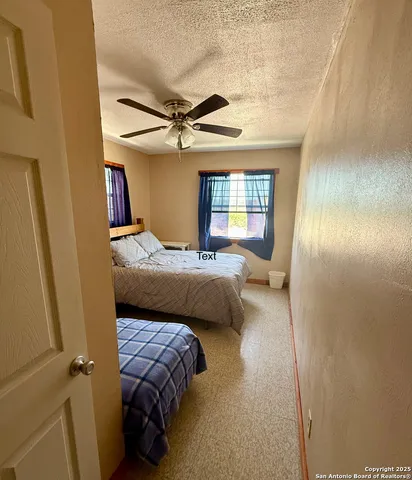 a bedroom with a bed couch and window