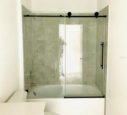 a bathroom with a glass shower door