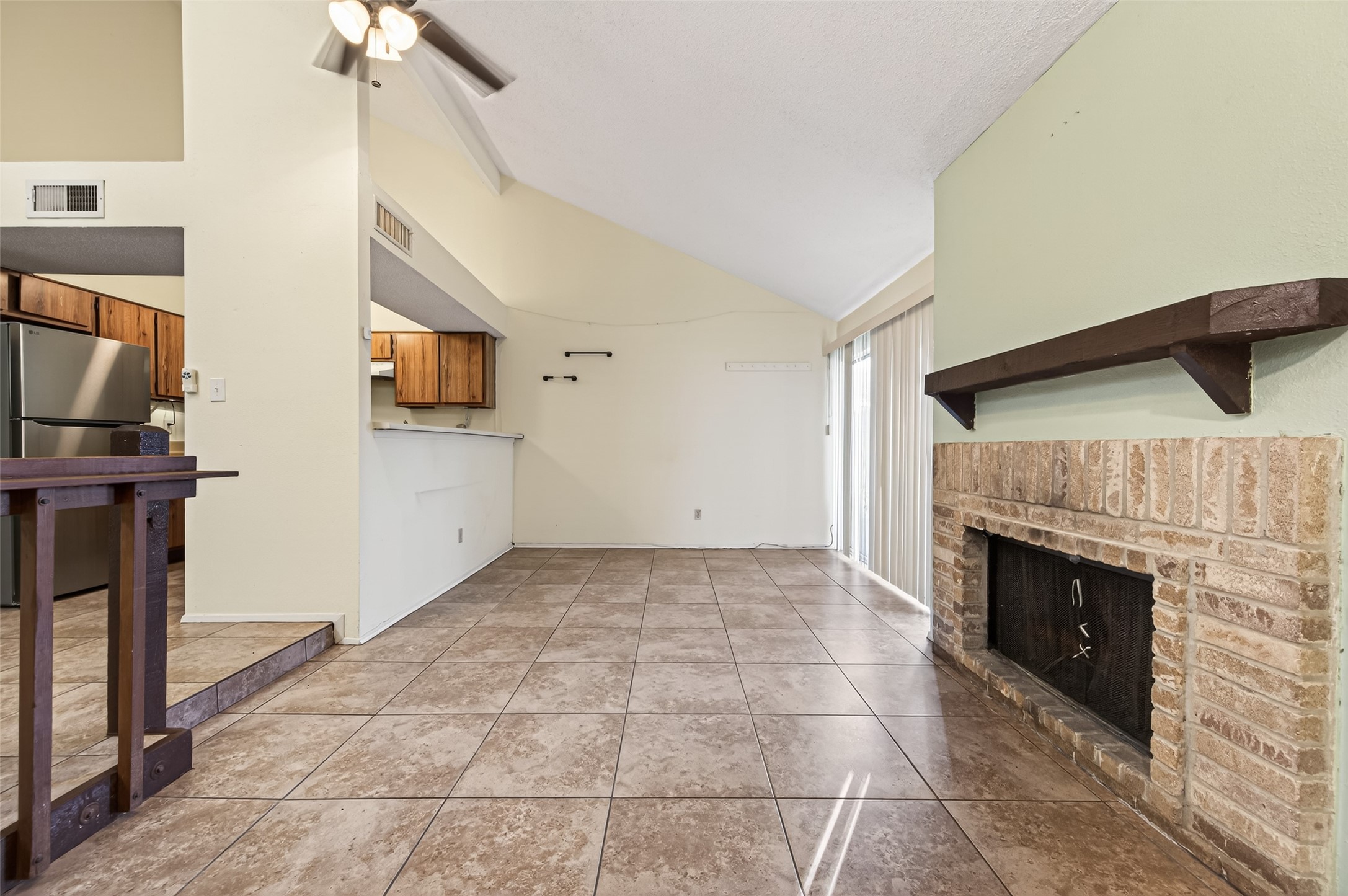 7082 Greenway Chase Street Houston, TX 77072 - Photo 12 of 43 a view of a livingroom with an empty space and a fireplace