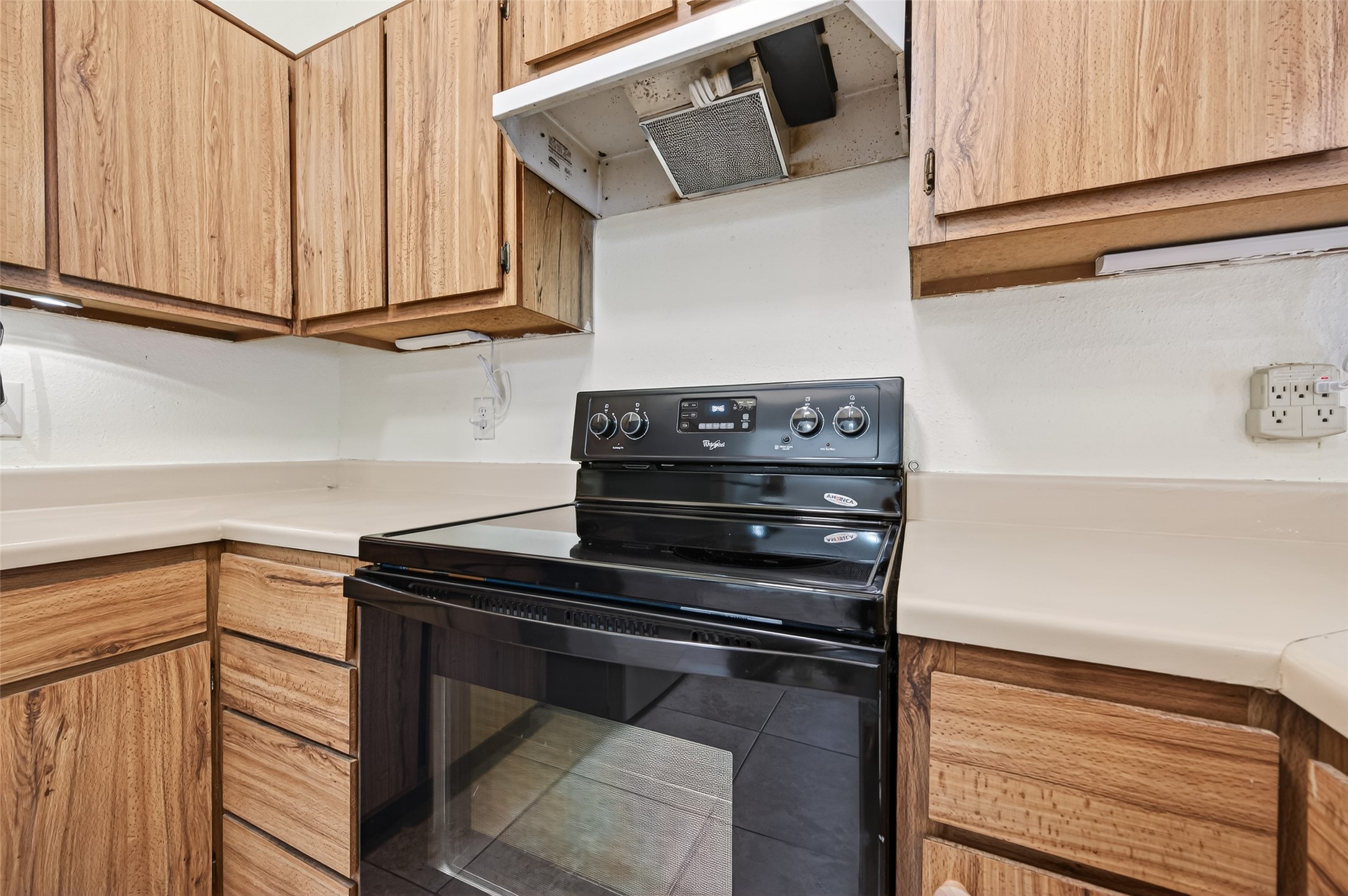 7082 Greenway Chase Street Houston, TX 77072 - Photo 25 of 43 a kitchen with wooden cabinets and a stove top oven