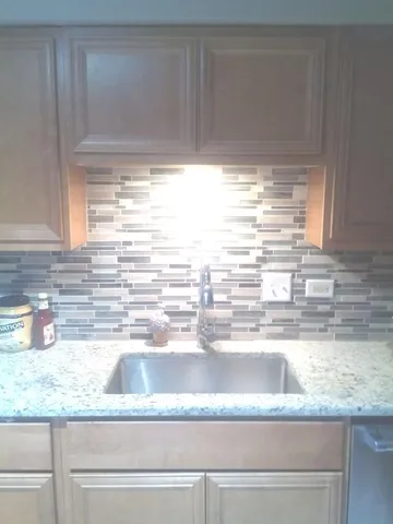 a kitchen with granite countertop a sink and a window