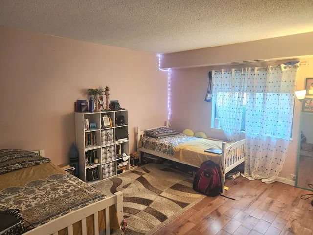 a bedroom with a bed and a book shelf