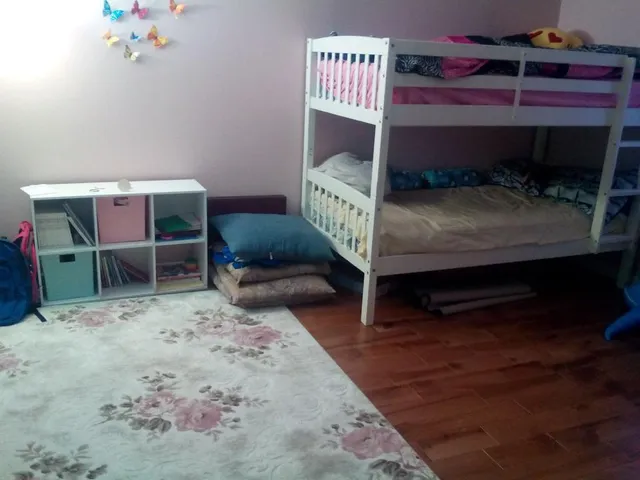 a bedroom with a bed and a chair in it