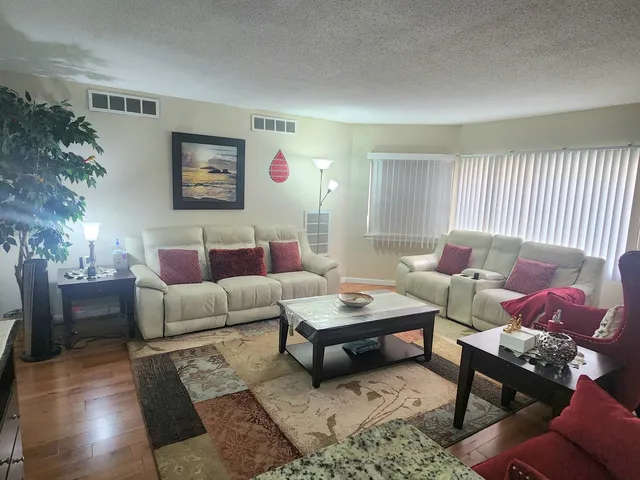 a living room with furniture and a potted plant