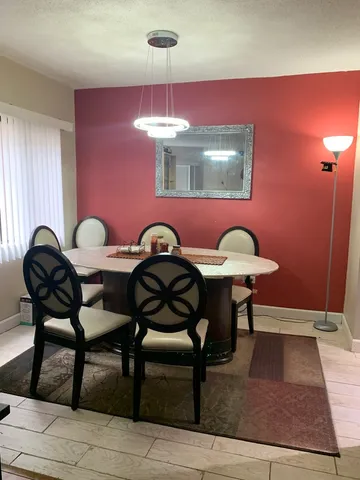 a view of a dining room with furniture and chandelier