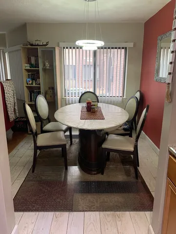 a dining room with furniture and chandelier