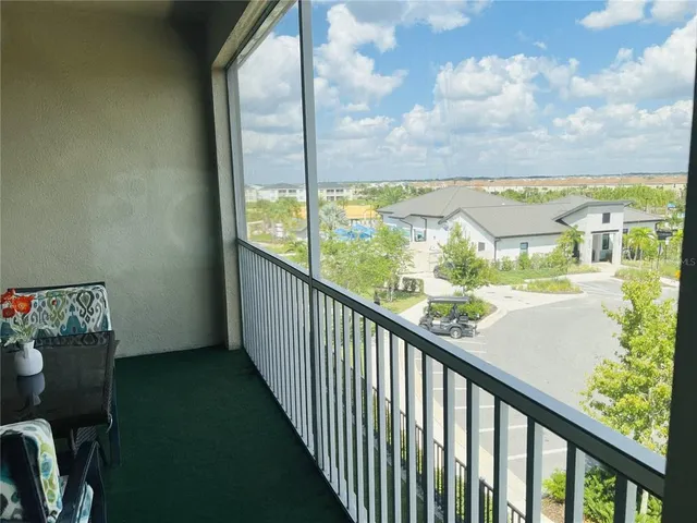 a dining room with furniture a chandelier and wooden floor